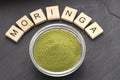 Moringa oleifera - Green and natural moringa powder in a bowl Royalty Free Stock Photo
