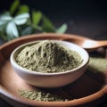 moringa oleifera powder in a bowl on a wooden plate Royalty Free Stock Photo