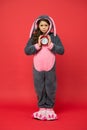 Morning alarm. Regular day beginning. Adorable bunny hold alarm clock. Small girl in bunny costume. Child rabbit