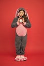 Morning alarm. Regular day beginning. Adorable bunny hold alarm clock. Small girl in bunny costume. Child rabbit