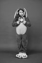 Morning alarm. Regular day beginning. Adorable bunny hold alarm clock. Small girl in bunny costume. Child rabbit