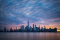 Morning atmosphere with colorful sky above Lower Manhattan cityscape.