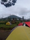 morning atmosphere with several tents with mountain views