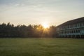 morning atmosphere at sunrise with green grass and building