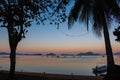 Morning on beach with trees and boats. Sunrise in Palawan island, Philippines. Tropical isles in morning dusk. Royalty Free Stock Photo