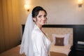 Morning of beautiful bride. Woman in white negligee in hotel Royalty Free Stock Photo