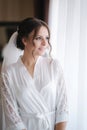 Morning of beautiful bride. Woman in white negligee in hotel Royalty Free Stock Photo