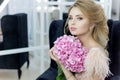 Morning of a beautiful tender sweet bride in a boudoir dress with a bouquet of hydrangea flowers with an evening hairdo and bright