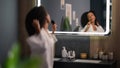 Morning beauty procedure happy girl at bathroom fun fooling sing song in hair brush dancing African American woman Royalty Free Stock Photo