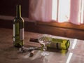 Morning after booze-up two empty bottles of red wine and glass t Royalty Free Stock Photo