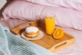 Morning breakfast in bed with fresh healthy and vitamin orange juice, half orange and doughnut in powdered sugar on a Royalty Free Stock Photo