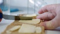 Morning Breakfast with Butter on the Toast, Spreading Margarine on a Fresh Slice of Bread in the Kitchen Royalty Free Stock Photo