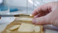 Morning Breakfast with Butter on the Toast, Spreading Margarine on a Fresh Slice of Bread in the Kitchen Royalty Free Stock Photo