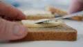 Morning Breakfast with Butter on the Toast, Spreading Margarine on a Fresh Slice of Bread in the Kitchen Royalty Free Stock Photo