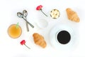 Morning breakfast coffee and croissant, butter, orange juice and flowers on white background. Flat lay Royalty Free Stock Photo