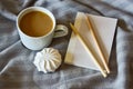 Morning breakfast coffee with marshmallows, notebook with pencil on a cozy plaid Royalty Free Stock Photo