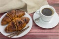 Morning snack with aromatic black coffee and French croissants. Royalty Free Stock Photo