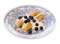 Morning breakfast with french crepes, fresh blueberry, yogurt on a plate isolated on white background.