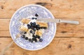 Morning breakfast with french crepes, fresh blueberry, yogurt on a plate on wooden table background.