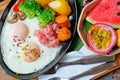 Breakfast - Fried eggs with sausages, fermented pork and vegetable served with toasts, coffee, orange juice and fruits Royalty Free Stock Photo