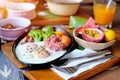 Breakfast - Fried eggs with sausages, fermented pork and vegetable served with toasts, coffee, orange juice and fruits Royalty Free Stock Photo