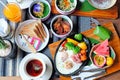 Breakfast - Fried eggs with sausages, fermented pork and vegetable served with toasts, coffee, orange juice and fruits Royalty Free Stock Photo