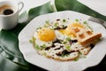 Morning breakfast with fried eggs ,toast and coffee in white cup and plant leaf on white table Royalty Free Stock Photo