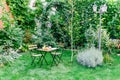 Morning Breakfast In Green Garden With French Croissant, Coffee Cup, Orange Juice, Tablet and Notes Book On Wood Table Royalty Free Stock Photo