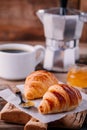 Homemade baked croissants with jam and coffee on wooden rustic background Royalty Free Stock Photo