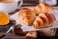 Homemade baked croissants with jam and coffee on wooden rustic background Royalty Free Stock Photo