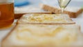 Morning Breakfast with Man Spreading Sweet Honey on the Toast, Fresh Honey on a Slice of Bread in the Kitchen Royalty Free Stock Photo