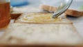 Morning Breakfast with Man Spreading Sweet Honey on the Toast, Fresh Honey on a Slice of Bread in the Kitchen Royalty Free Stock Photo