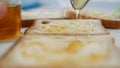 Morning Breakfast with Man Spreading Sweet Honey on the Toast, Fresh Honey on a Slice of Bread in the Kitchen Royalty Free Stock Photo