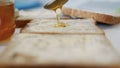 Morning Breakfast with Man Spreading Sweet Honey on the Toast, Fresh Honey on a Slice of Bread in the Kitchen Royalty Free Stock Photo