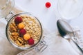 Morning breakfast, oatmeal with red and yellow raspberries and walnuts in a glass ja Royalty Free Stock Photo