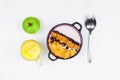 Morning breakfast. Spoon, bowl with homemade yogurt and cornflakes, raisins, almonds, green apple and orange juice on white Royalty Free Stock Photo