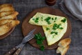 Morning breakfast of a traditional French omelet with toasts and butter, chopped parsley and a white porcelain cup of coffee on a Royalty Free Stock Photo