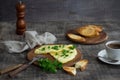 Morning breakfast of a traditional French omelet with toasts and butter, chopped parsley and a white porcelain cup of coffee on a Royalty Free Stock Photo