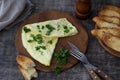 Morning breakfast of a traditional French omelet with toasts and butter, chopped parsley and a white porcelain cup of coffee on a Royalty Free Stock Photo