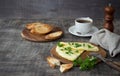 Morning breakfast of a traditional French omelet with toasts and butter, chopped parsley and a white porcelain cup of coffee on a Royalty Free Stock Photo