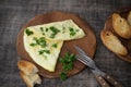 Morning breakfast of a traditional French omelet with toasts and butter, chopped parsley and a white porcelain cup of coffee on a Royalty Free Stock Photo