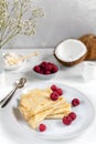 Morning, breakfast - traditional russian blini pancakes, french crepes served with fresh raspberries, coconut