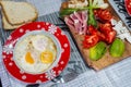 Morning breakfast for two people top view fried eggs tomato avocado ham cheese white bread Royalty Free Stock Photo