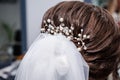 The morning of the bride. Girl makes a stylish hairstyle, a friend helps the bride, a beautiful hair ornament