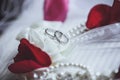 Morning bride. Wedding rings, rose petals and pearl necklace. We Royalty Free Stock Photo