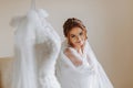 The morning of the bride in a white robe and an elegant hairstyle Royalty Free Stock Photo