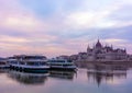 Morning in Budapest, parliament against the backdrop of a dramatic sky, ships on the river, reflected in the water Royalty Free Stock Photo