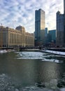 Morning in Chicago with interesting cloudscape over icy Chicago River in winter. Royalty Free Stock Photo
