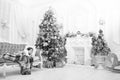 Morning before christmas. Little girl lay on couch near christmas tree beautiful interior. Magical moment. Excited Royalty Free Stock Photo