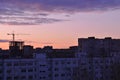 Morning city panorama with a view of residential apartment buildings, a tower crane and a high-rise building under construction Royalty Free Stock Photo